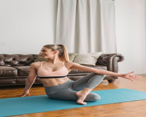 Woman doing light yoga stretching for energy balance